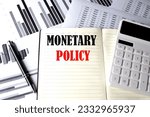 MONETARY POLICY text written on notebook on chart and diagram