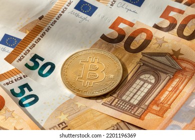 Monetary Role Change Between Cryptocurrency And Fiat Money. Bitcoin Coin Over 50 Euros Banknotes Background.