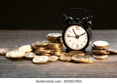 money background, coins and alarm clock on wooden table, concept of bank deposits, compound interest, inflation, taxes and finance consultant