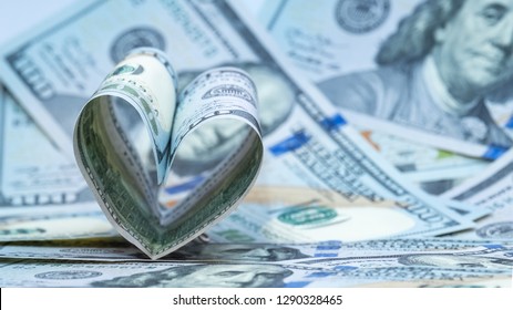 Money Background. One Hundred Dollars US Banknote In The Shape Of A Heart. Concept Financial Love And A Gift For Valentine's Day. Copy Space.