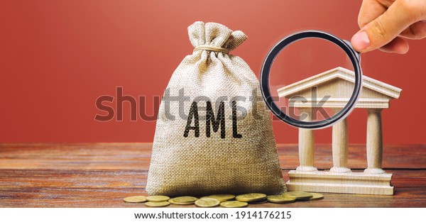 Money bag AML and\
bank building. Anti Money Laundering concept. Financial monitoring,\
Identification of suspicious transactions. Business and finance.\
Fight against criminal\
money
