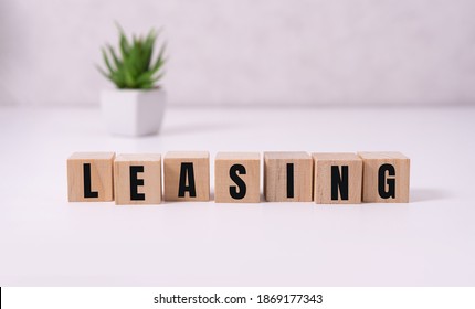 Money bag and blocks with the word Leasing. A lease is a contractual arrangement calling for the lessee to pay the lessor for use of an asset. Property, vehicles are common assets that are leased - Shutterstock ID 1869177343
