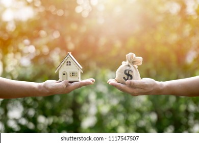 Money bag and houses show savings to buy a home or buy real estate. Or show a home loan Or divide the investment for retirement. Or for the future Concept of money - Shutterstock ID 1117547507
