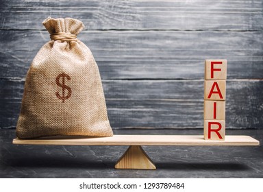 Money bag and wooden blocks with the word Fair. Balance. Fair value pricing, money debt. Fair deal. Reasonable price. Justified risk. Honest loan. Secured loans. - Shutterstock ID 1293789484