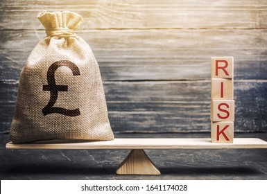 Money Bag And Wooden Blocks With The Word Risk On The Scales. Business Risk Management And Assessment. Strategic, Financial And Operational Risks. Insurance. Economics And Finance. Brexit