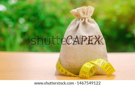 Money bag with the word Capex ( capital expenditure) and tape measure. Capital used by companies to acquire or upgrade physical assets. Business management concept