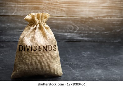 Money bag with the word Dividends. A dividend is a payment made by a corporation to its shareholders as a distribution of profits. Concept business finance and investment. Saving money. Dividend tax