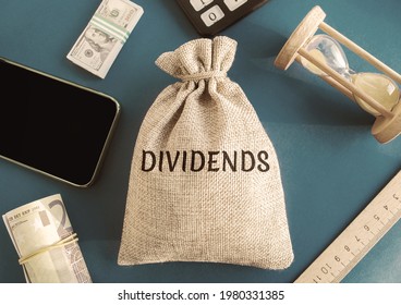 Money Bag With The Word Dividends. Payment Made By A Corporation To Its Shareholders As A Distribution Of Profits. Concept Business Finance And Investment. Dividend Tax