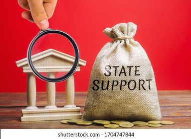 Money Bag With The Word State Support And The Bank Building. Tax Relief. Protection Of Manufacturers In The Domestic Market And Promotion In Foreign Markets. Exemption From Taxes. Small Business