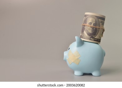 Money Banknote And Piggy Bank With Band Aids. Copy Space