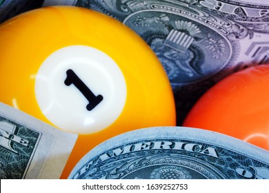 Money and billiard balls close up. Banknotes in the game. Success. Multi-colored billiard balls with numbers hug dollars. Active leisure and entertainment.                              