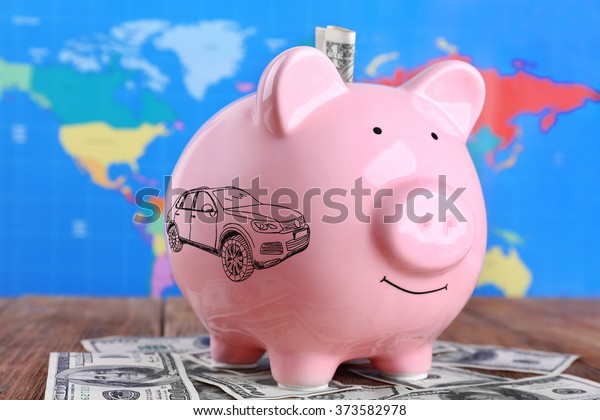 Money box pig on world\
map background