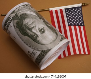 Money Box For Money Is Worth On Background The American Flag. American Dollar In A Casket With A Flag.