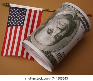 Money Box For Money Is Worth On Background The American Flag. American Dollar In A Casket With A Flag.