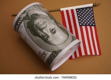 Money Box For Money Is Worth On Background The American Flag. American Dollar In A Casket With A Flag.