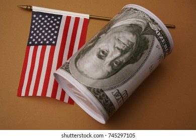 Money Box For Money Is Worth On Background The American Flag. American Dollar In A Casket With A Flag.