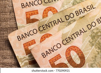 Money From Brazil. Notes Of Real, Brazilian Currency. Concept Of Economy, Inflation And Business. Group Of Bills On Wooden Table