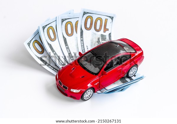 Money to buy or rent a car concept. Toy car with\
money cash