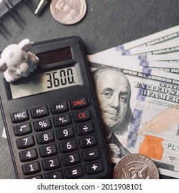 Money And Calculator With A Kids Toy On A Table; Child Stimulus Tax Credit Concept