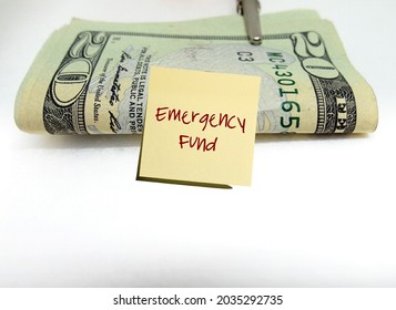 Money Cash Dollars Clip On Copy Space White Background With Yellow Stick Note Written EMERGENCY FUND, Means To Save Small Cash Regularly For Crisis Unexpected Life Crisis Expenses 