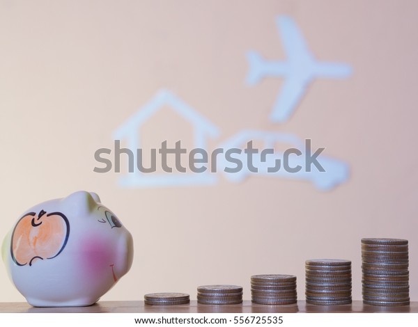 money coin stack with paper cut of a home,\
plane, car background, Saving money\
concept.