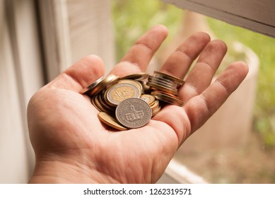 Money in coins in hand. Argentine coins.