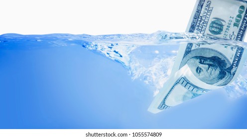 Money concept showing US Dollar sinking in water as a symbol of global economic crisis