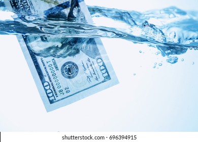 Money Concept Showing US Dollar Sinking In Water As A Symbol Of Global Economic Crisis