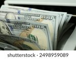 Money counter machine with dollar banknotes, closeup