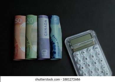 Money or currency. Canadian dollar (CAD) banknote on black background. Concept for finance, economy, budget and investment.