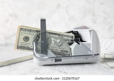 Money In Currency Counting Machine On Light Background