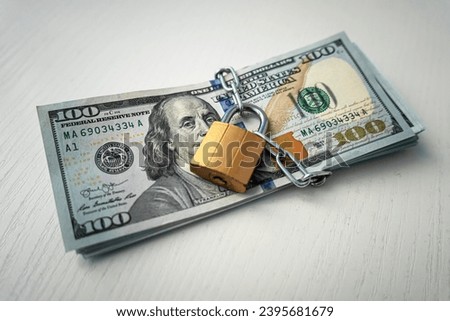 money dollars in a chain with a lock on the background of white. The concept of banning dollars. the concept of keeping or banning cash dollars. money is banned.