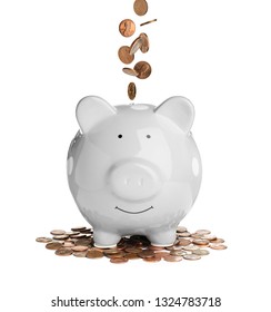 Money Falling Into Piggy Bank On White Background