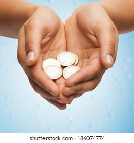 money and finances concept - close up of womans cupped hands showing euro coins - Powered by Shutterstock