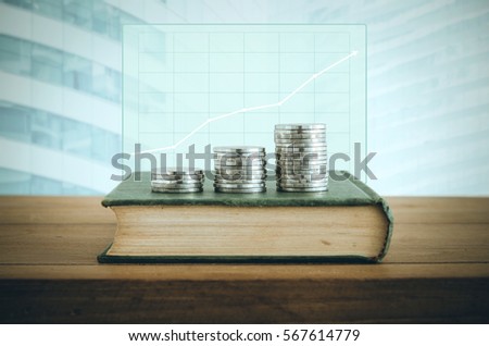 Money, Financial, Business Growth concept, Coin stacks on old book with financial graph. Vintage filter.