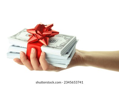 Money gift in a female hand, isolated on white transparent background, US dollars stack and red bow, festive present. 