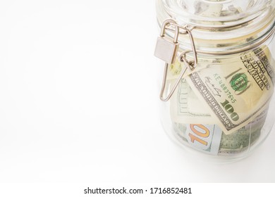 Money In A Glass Jar, Dollars, Savings Under Lock And Key, The Conceptual Idea Of Keeping Cash