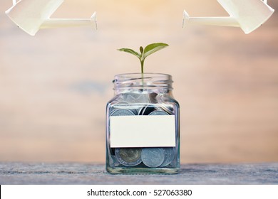 Money In A Glass Jar With Watering. Concept Siphons Money,vintage Tone And Sunlight