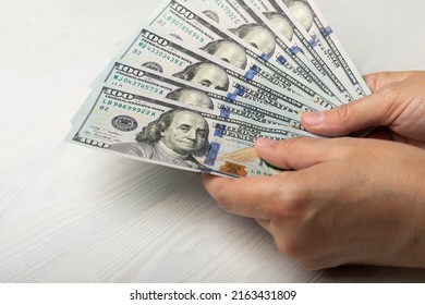 Money In Hand. US Hundred Dollar Banknotes On A White Texture Background. Money Account. Concepts Of Finance And Economy. Money Accumulation Concept. Saving Currency. Investments. Copy Space.