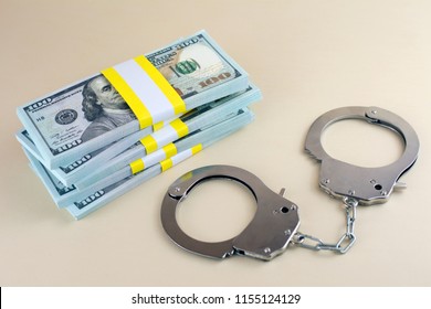 Money And Handcuffs. Financial Crime Advance Fee Scams  Card Fraud Concept