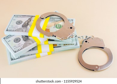 Money And Handcuffs. Financial Crime  Advance Fee Scams Concept