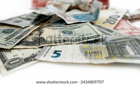  Money isolated on white. Assorted Turkish lira notes with US dollars and euros on a bright surface.