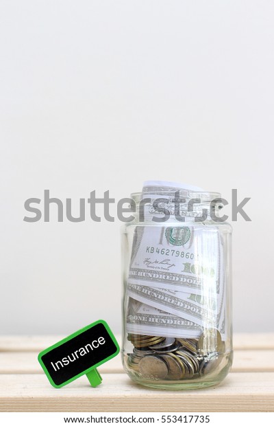 Money jar\
with coins on wood table , Saving\
Concept