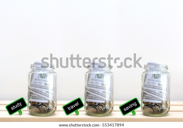Money jar
with coins on wood table , Saving
Concept