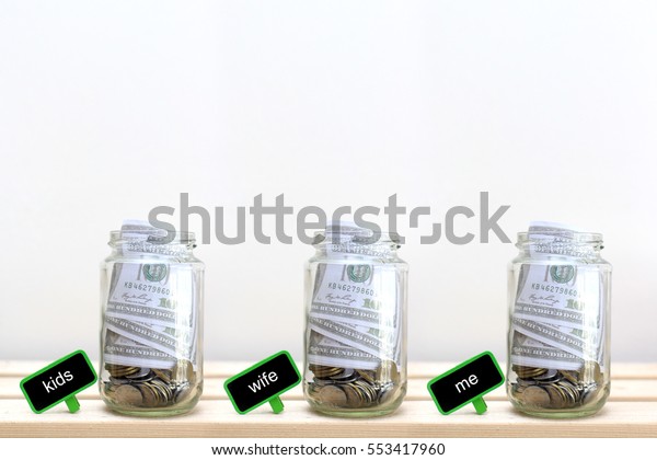 Money jar\
with coins on wood table , Saving\
Concept