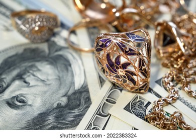 money and jewelry, pawn shop and buy and sell golden rings, necklace bracelet o wooden background, closeup