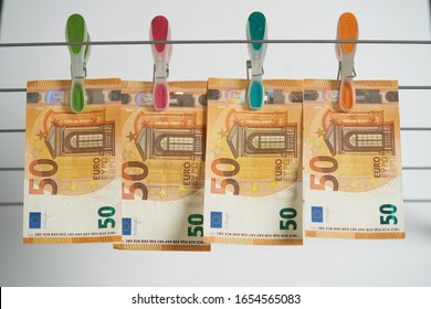 Money laundering on clothesline isolated on white background.