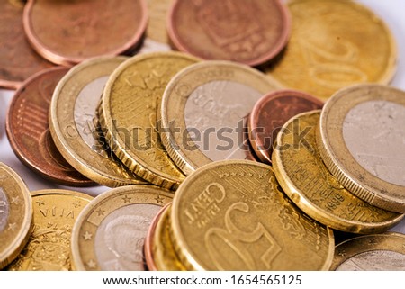 Money laundering on clothesline on light background. Handful of coins. Scattering of coins. Euro cent coins 