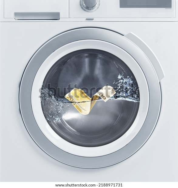 Money laundering. Two hundred euro banknote in\
washing machine