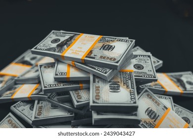 Money lies on a black background. Packed stacks of one hundred dollar bills lie in a large pile on a black background. Close-up. Much money. - Powered by Shutterstock